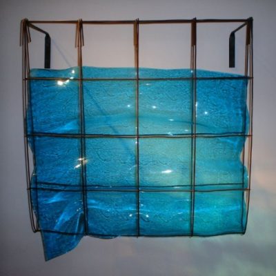 Blue slumped glass in metal wall hanging by Mary Shaffer